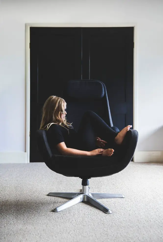 What to look for in an ergonomic office chair - Woman lying sideways on swivel chair