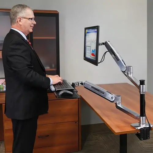 Ergotron WorkFit-LX sit-stand desk mount system review - man standing at desk