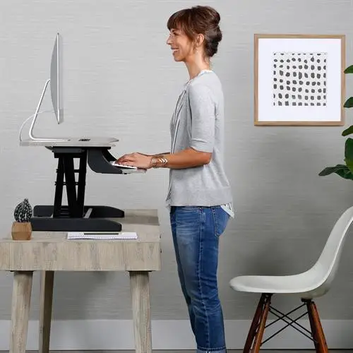 Ergotron Workfit-Z Mini Sit-Stand Desktop - woman standing at standing desk converter