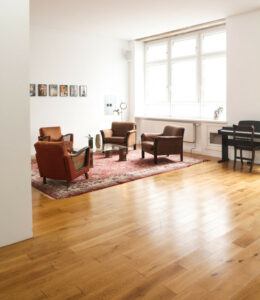 Best Home Office Flooring - Wooden floor in room with chairs